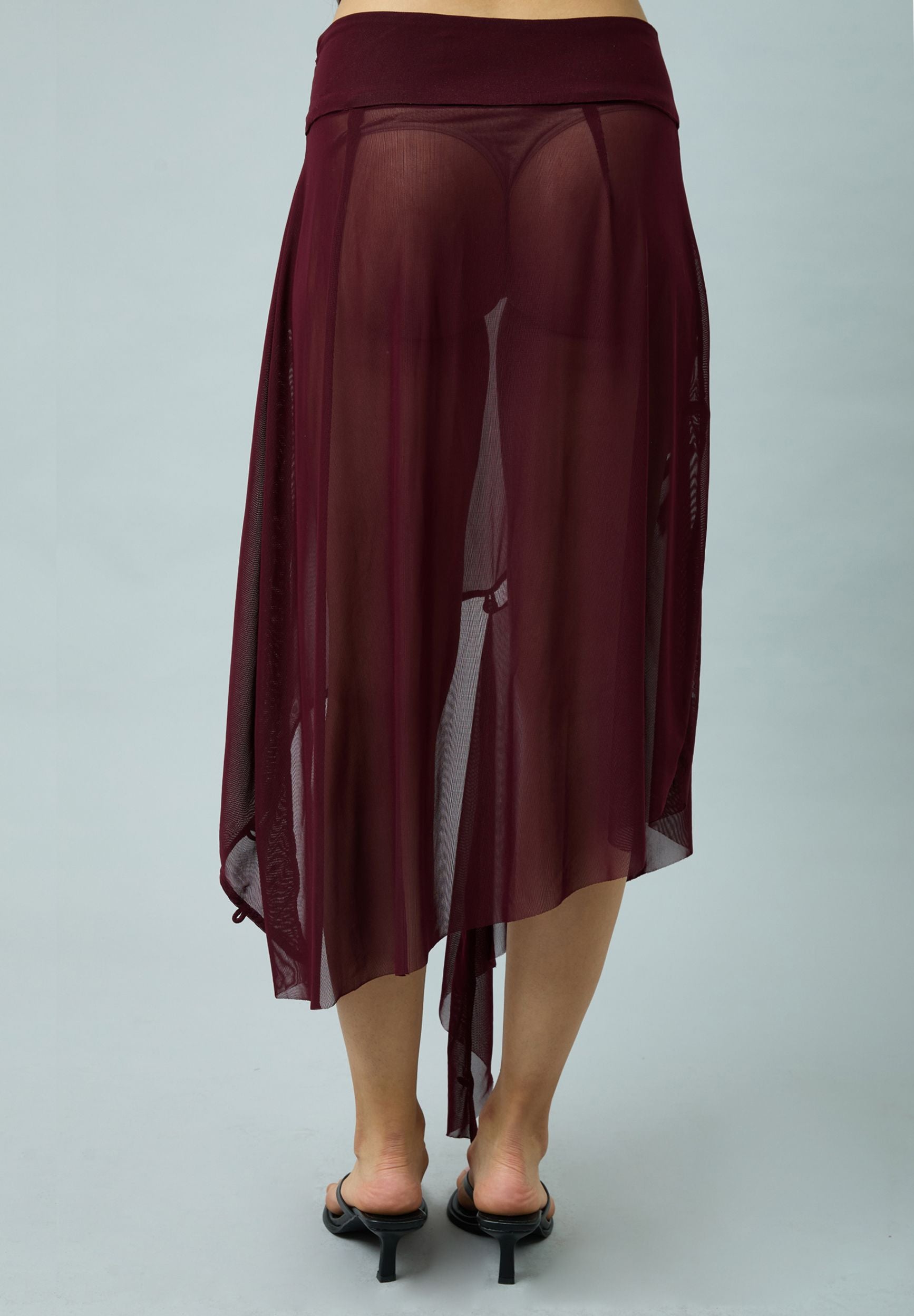 ASYMMETRIC MESH SKIRT WITH FLOWER APPLIQUE