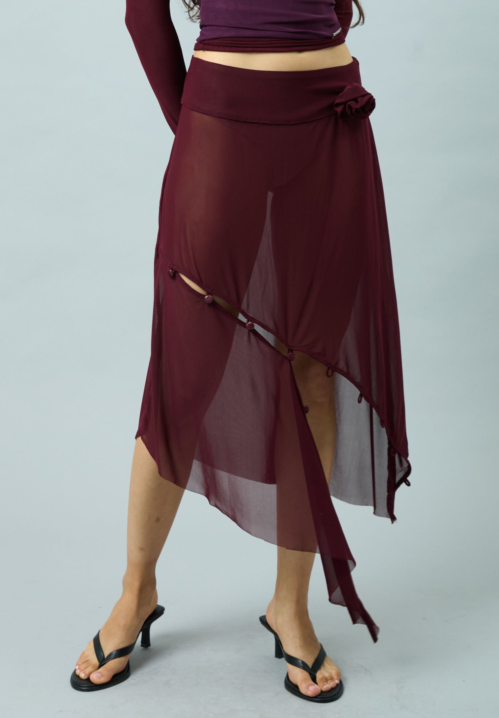 ASYMMETRIC MESH SKIRT WITH FLOWER APPLIQUE