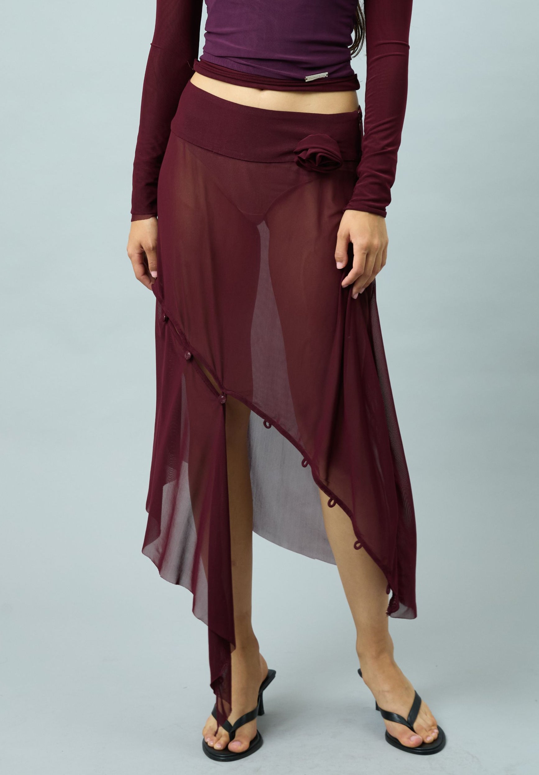 ASYMMETRIC MESH SKIRT WITH FLOWER APPLIQUE